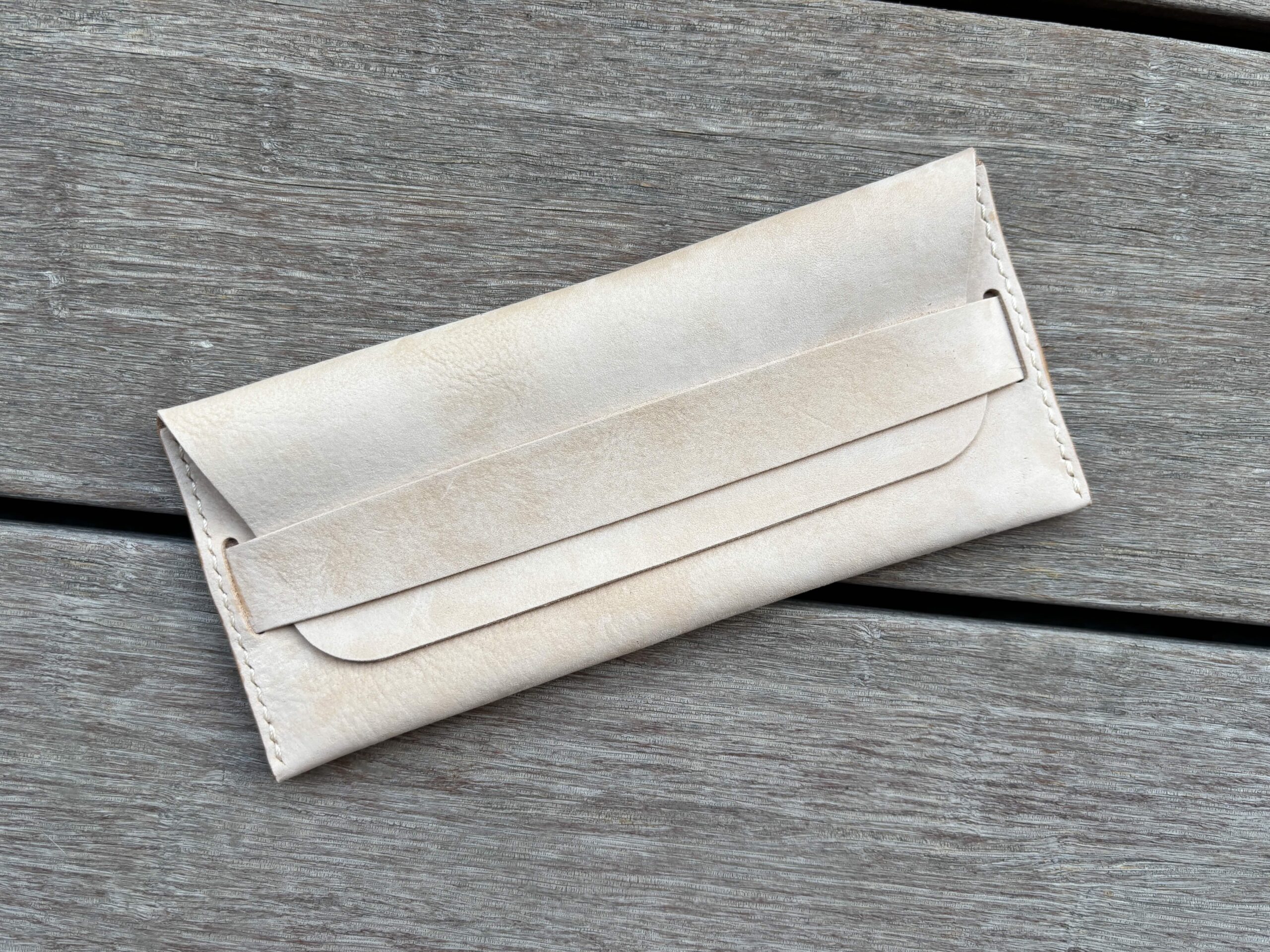 Slide – Leather horizontal long wallet with strap closure